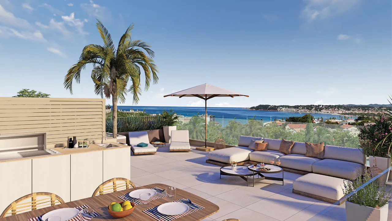 Rooftop avec cuisine d'été, table dressée et vue sur la baie